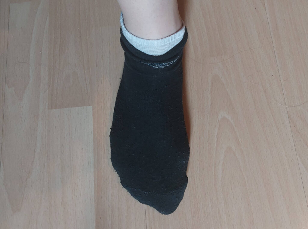 two pairs of socks worn over each other